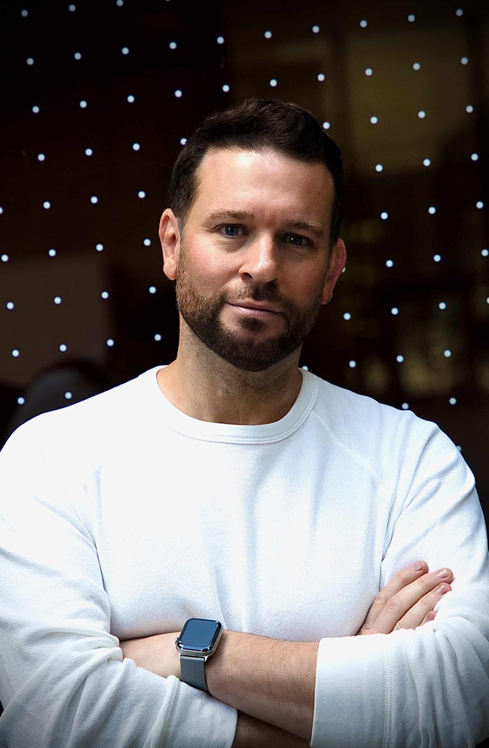 A photograph of entrepreneur Gregory S. McNeal in a white Todd Snyder sweater. 